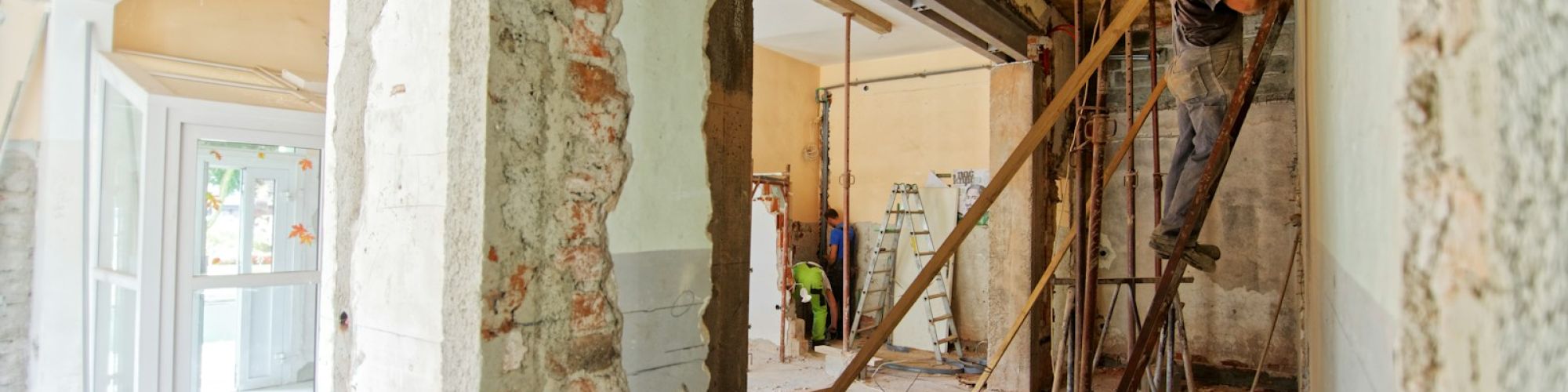 man climbing on ladder inside room